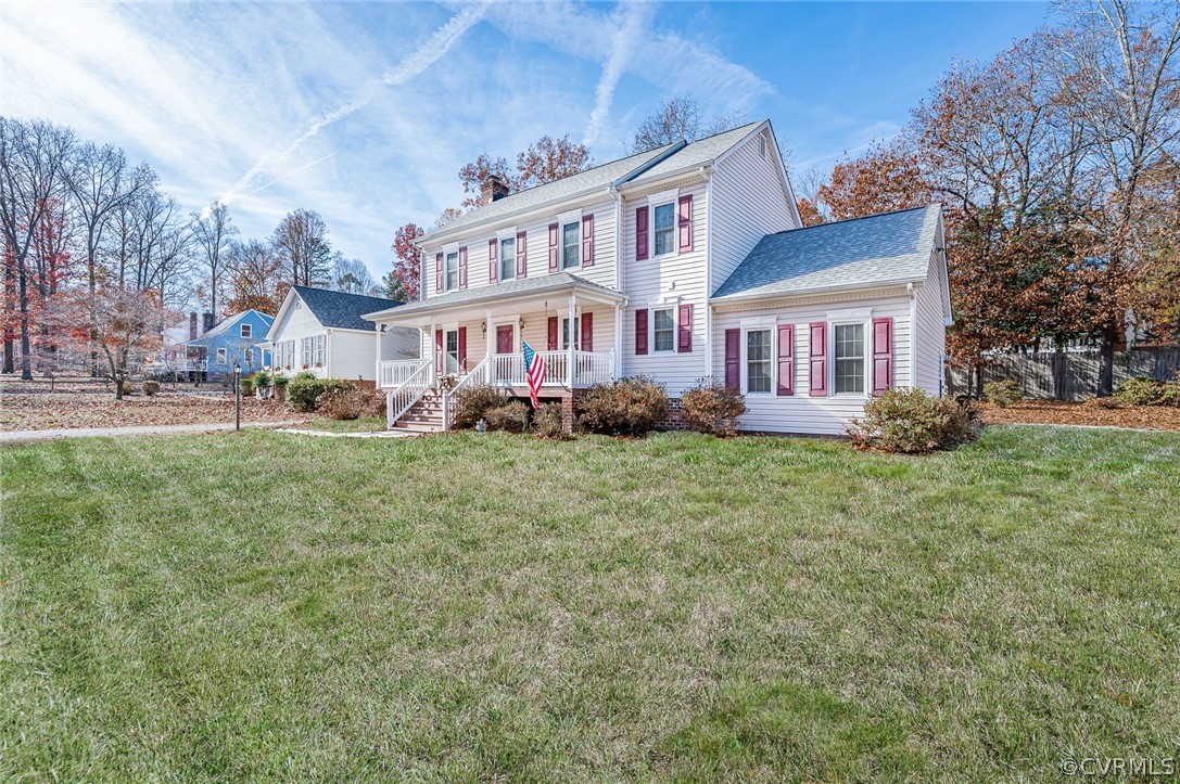 10900 Crofton Road Chester, VA 23831 - Photo 4 of 32 a front view of a house with a garden and trees