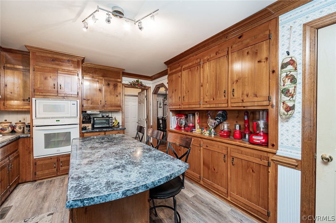 10900 Crofton Road Chester, VA 23831 - Photo 8 of 32 a kitchen with stainless steel appliances granite countertop a refrigerator a stove and a wooden floors