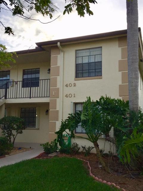 402 Pinecrest Circle, Unit F Jupiter, FL 33458 - Photo 1 of 10 a front view of a house with a garden