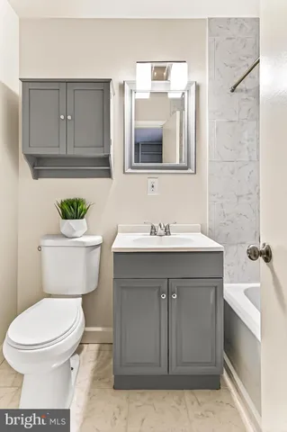 a bathroom with a sink toilet and mirror