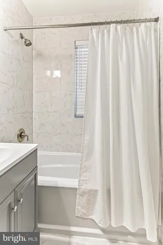 a bathroom with a shower and a sink