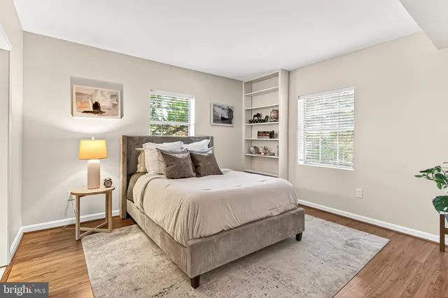 a bedroom with a bed lamp and a window