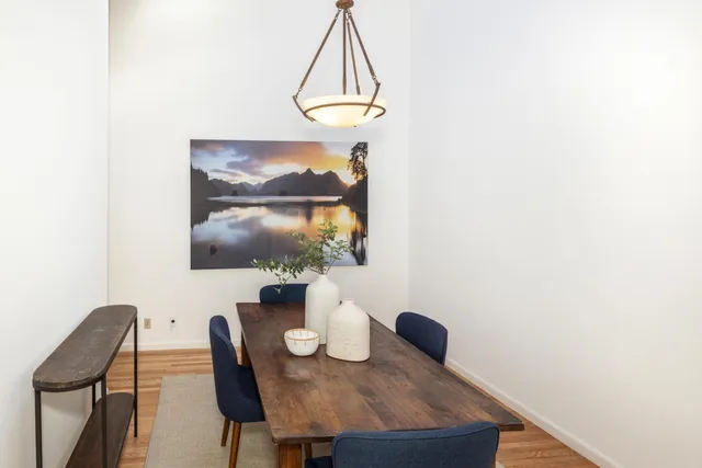 a view of a dining room with furniture and wooden floor