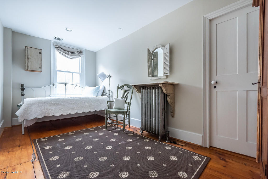 21 Summit Road Richmond, MA 01254 - Photo 22 of 51 a bedroom with a bed and wooden floor