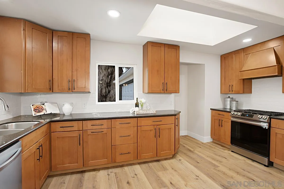 9350 Rapture Lane Santee, CA 92071 - Photo 11 of 30 a kitchen with stainless steel appliances granite countertop a sink stove and refrigerator