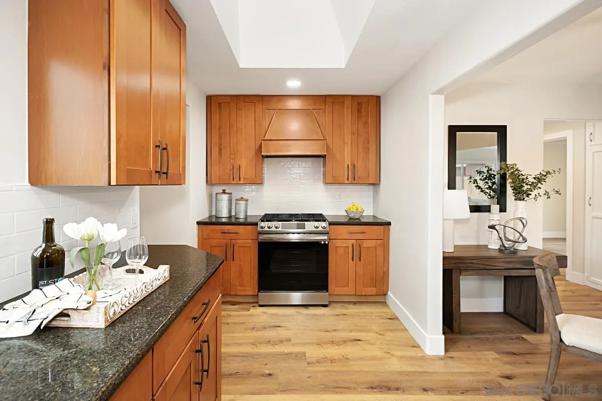 9350 Rapture Lane Santee, CA 92071 - Photo 12 of 30 a kitchen with stainless steel appliances granite countertop a stove and a sink