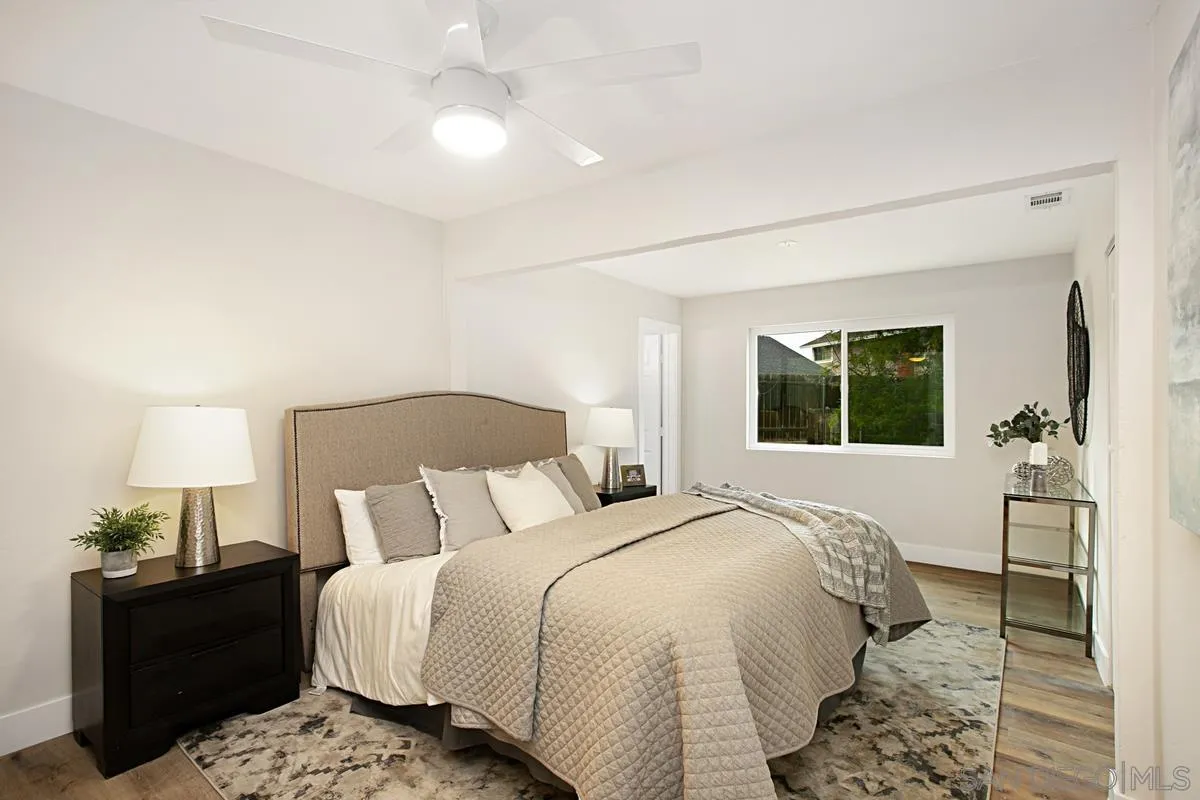 9350 Rapture Lane Santee, CA 92071 - Photo 15 of 30 a bedroom with a bed and a lamp on dresser