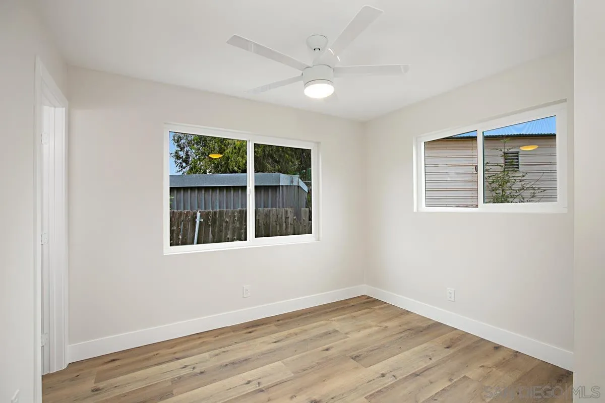 9350 Rapture Lane Santee, CA 92071 - Photo 20 of 30 an empty room with wooden floor and windows