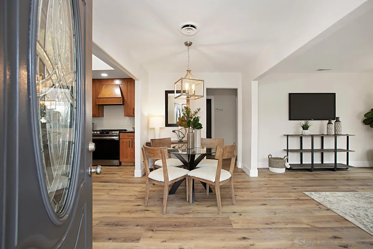 9350 Rapture Lane Santee, CA 92071 - Photo 5 of 30 a living room with furniture a flat screen tv and a dining table