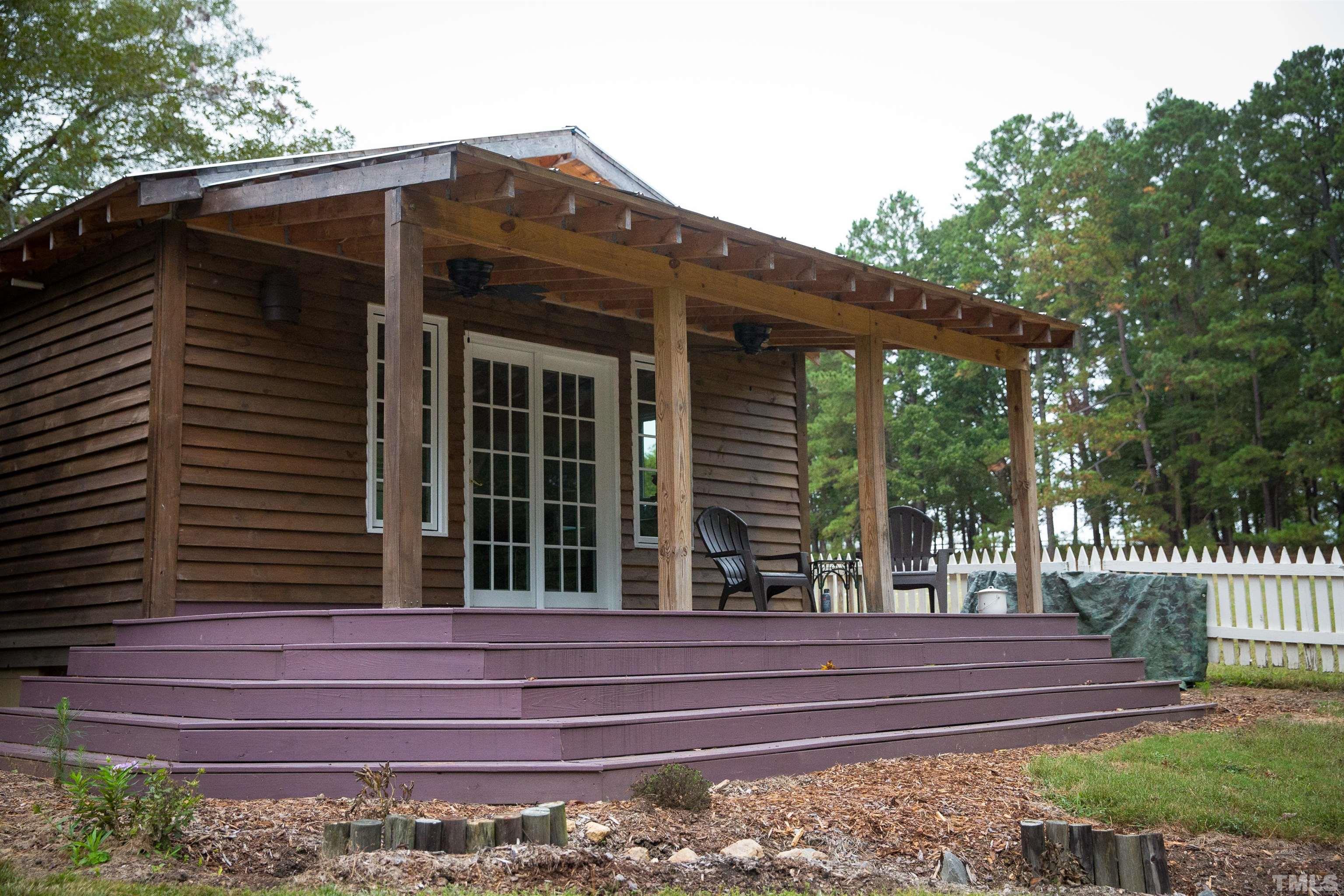 395 Cecil Road Wendell, NC 27591 - Photo 20 of 29 a view of a house with a small cabin