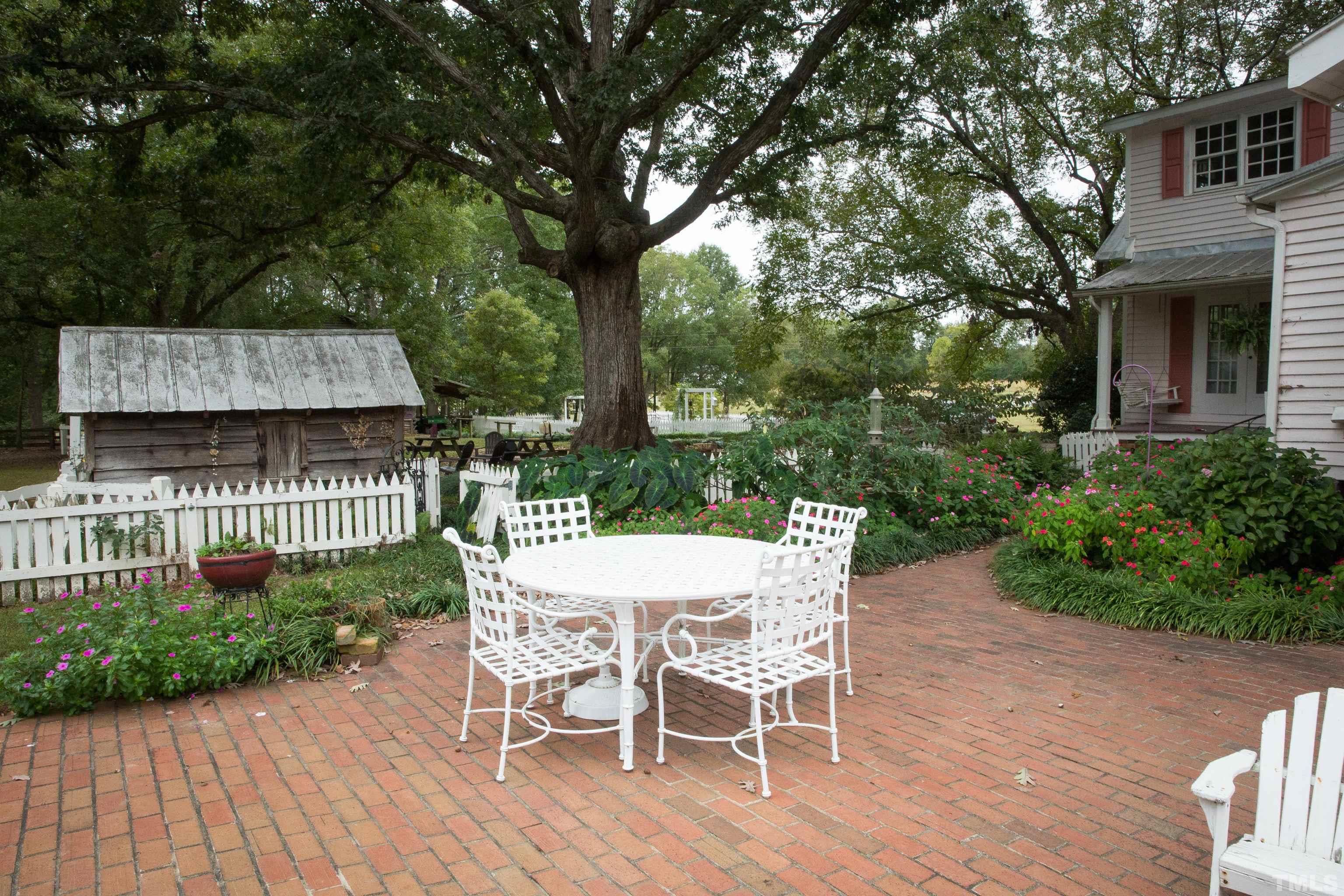 395 Cecil Road Wendell, NC 27591 - Photo 22 of 29 a view of a patio with table and chairs and potted plants with wooden floor and fence