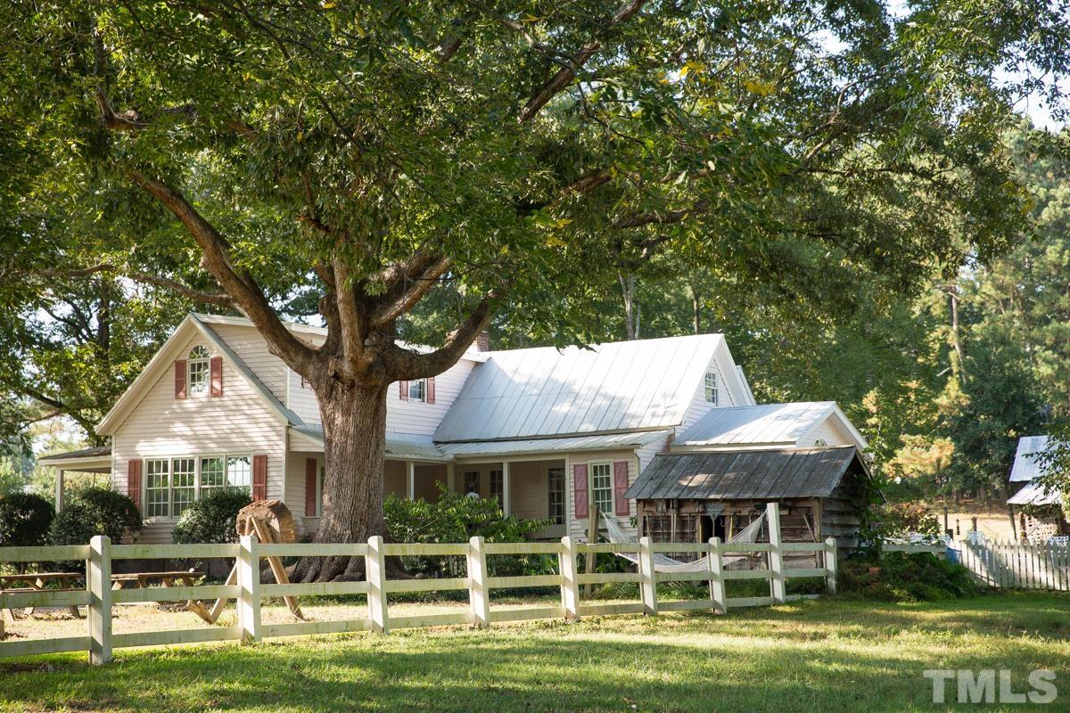 395 Cecil Road Wendell, NC 27591 - Photo 4 of 29 a front view of a house with a garden and trees
