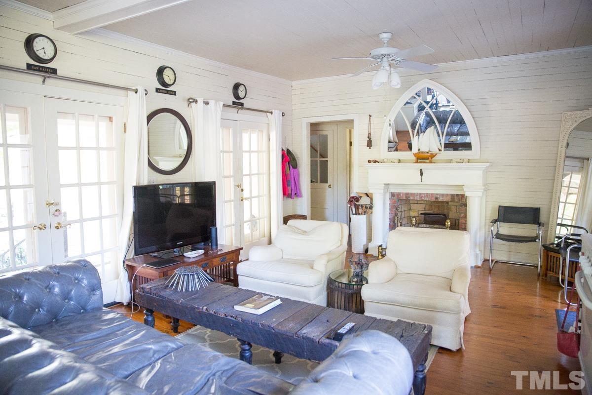 395 Cecil Road Wendell, NC 27591 - Photo 7 of 29 a living room with furniture a flat screen tv and a fireplace