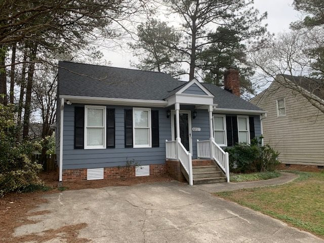 4857 Draper Road Raleigh, NC 27616 - Photo 2 of 3 a front view of a house with a garden and porch
