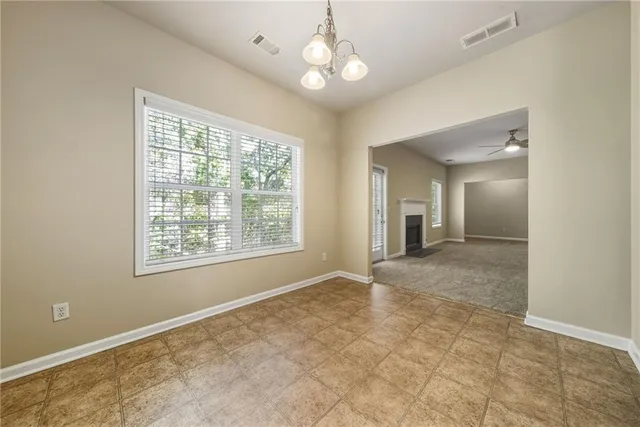 a view of an empty room with a fireplace