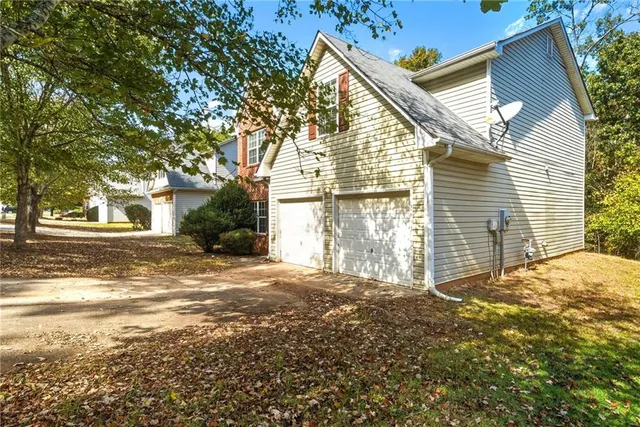 a view of a house with a yard and garage