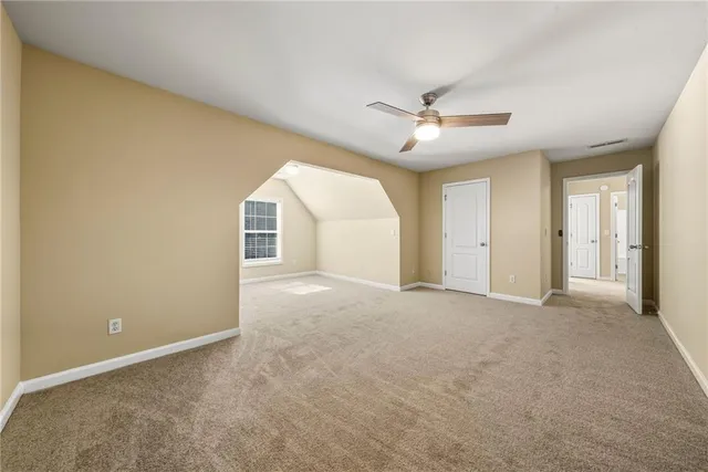 a view of a swimming pool with a table and chairs under an umbrella