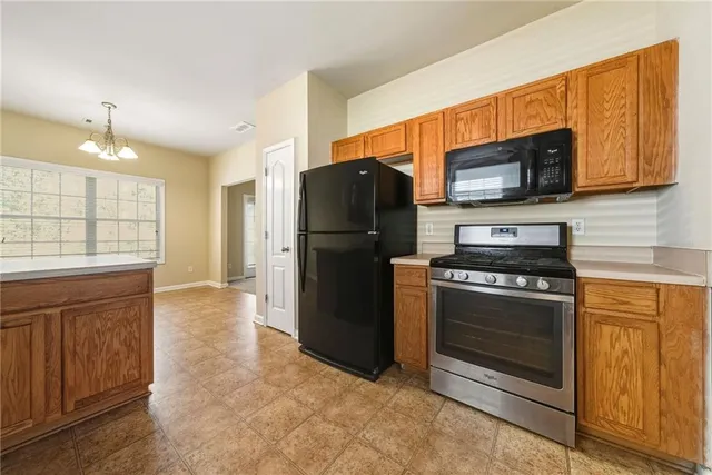 a kitchen with a sink stove and refrigerator