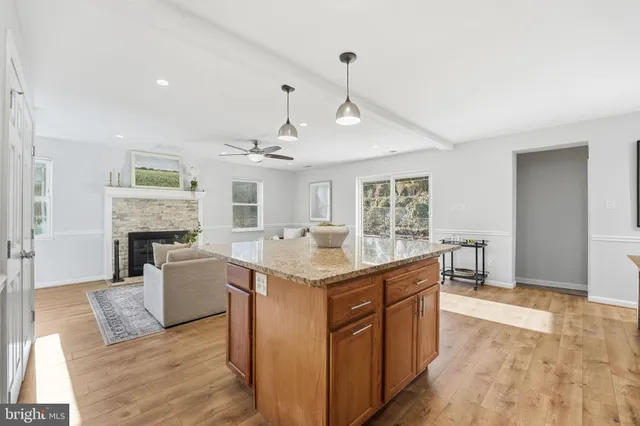 a kitchen with granite countertop a sink and a stove