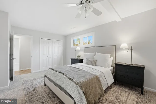 a spacious bedroom with a bed and a chandelier