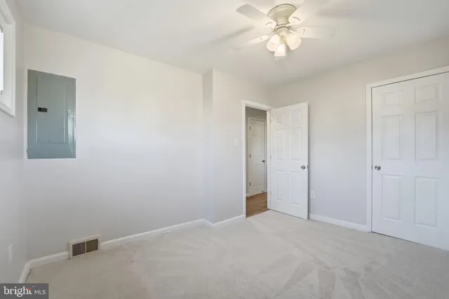 a view of a chandelier fan and closet in a room