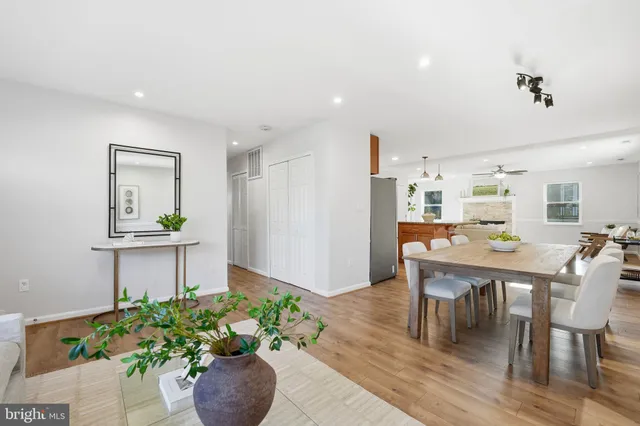 a dining room with furniture and a potted plant