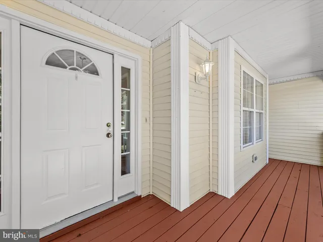 a view of a hallway with wooden floor and closet