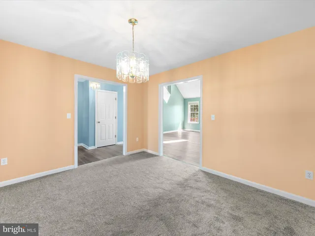 a view of a chandelier in big room and chandelier