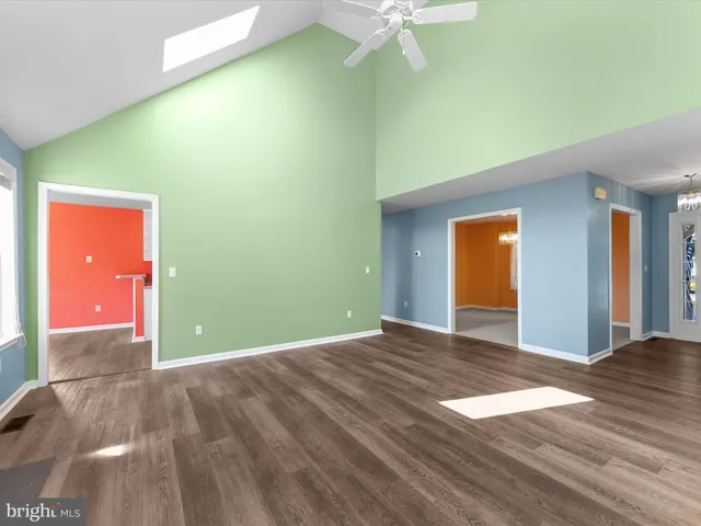 a view of a big room with wooden floor and fan