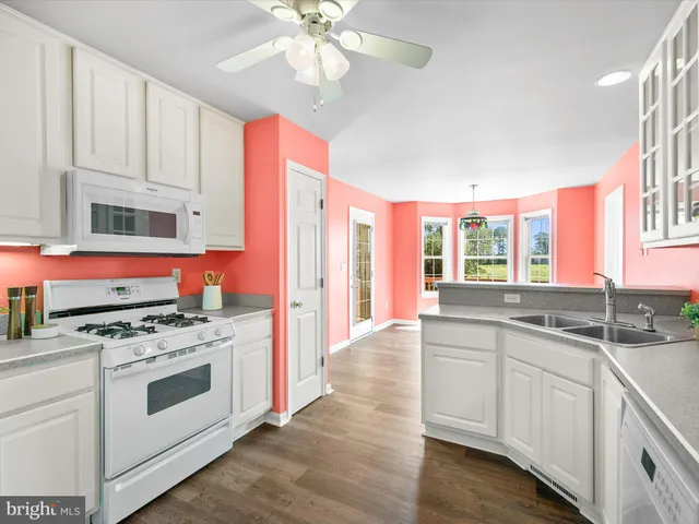 a kitchen with stainless steel appliances granite countertop a sink and cabinets