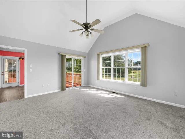 a view of a livingroom with a ceiling fan and window