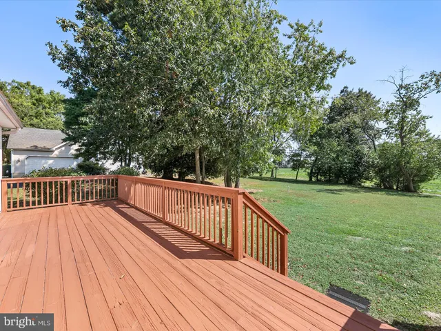 a view of balcony with wooden floor and fence