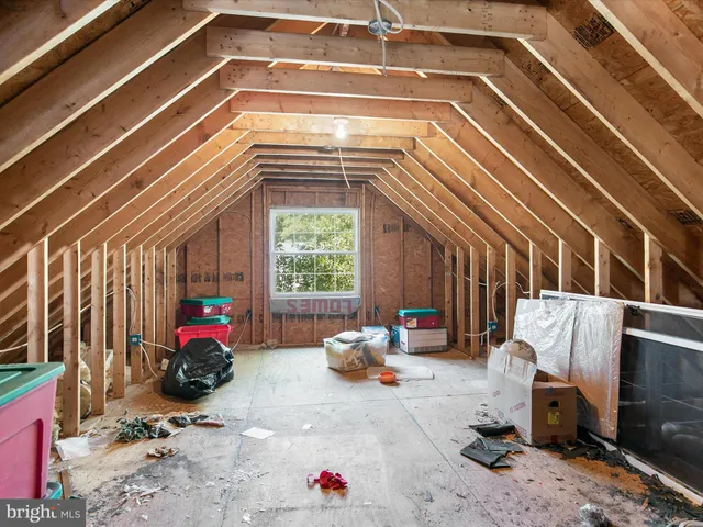 a front view of a house with a garden and trees