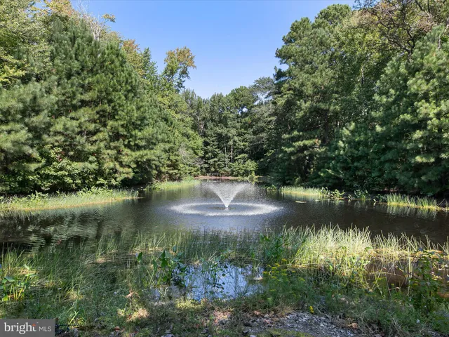 a view of a house with a yard and basketball court