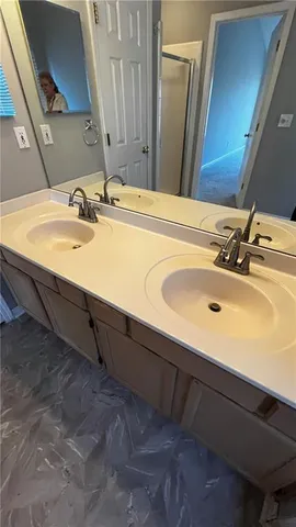 a bathroom with a sink vanity and mirror