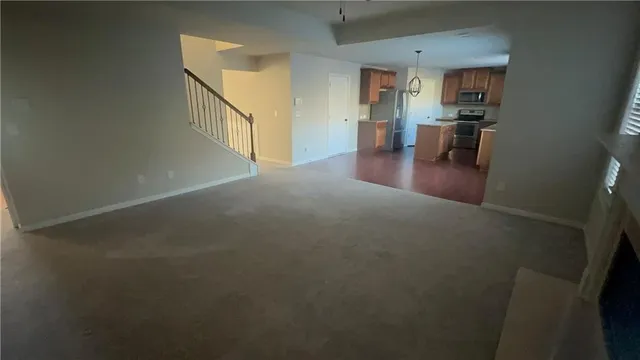 a view of a livingroom with furniture and a window