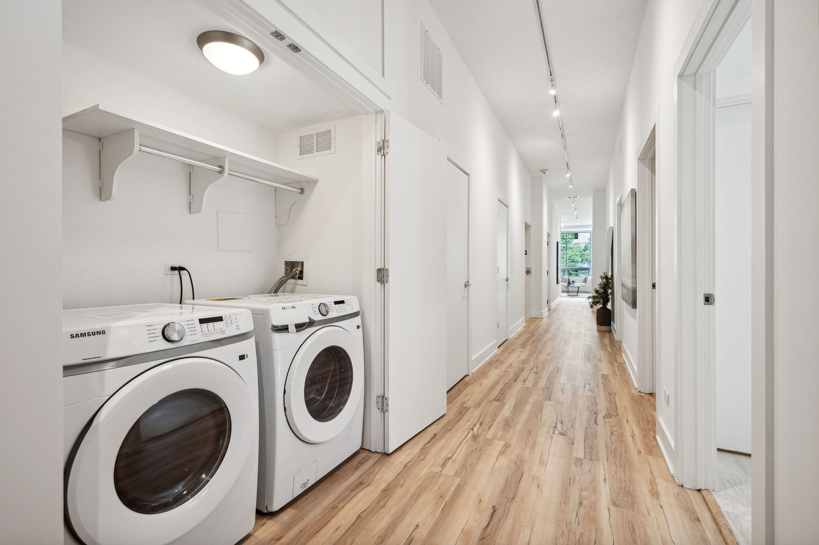 16 North Carpenter Street, Unit 2S Chicago, IL 60607 - Photo 19 of 21 a view of a hallway with washer and dryer