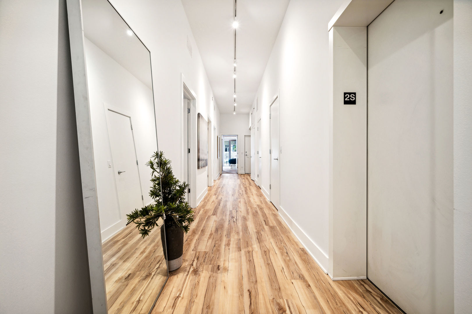 16 North Carpenter Street, Unit 2S Chicago, IL 60607 - Photo 10 of 21 a view of a hallway with wooden floor and staircase