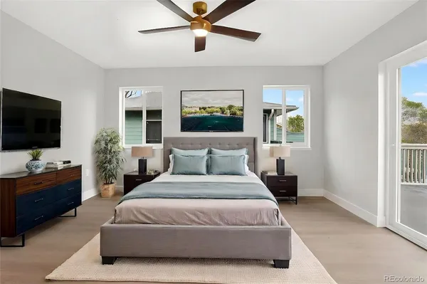 a spacious bedroom with a bed and a flat screen tv