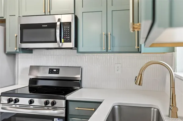 a kitchen with a stove and a microwave