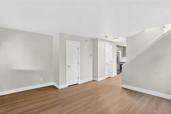 a view of an empty room with wooden floor