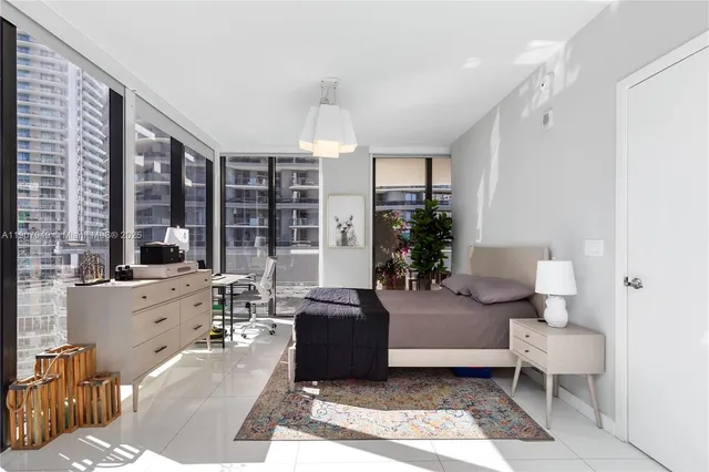 a living room with furniture large window and table