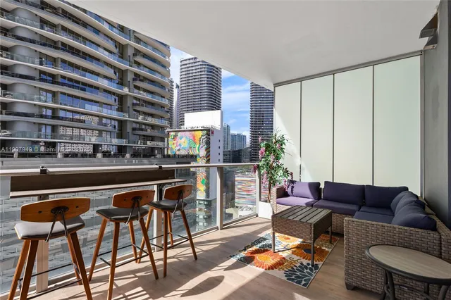 a living room with furniture and a floor to ceiling window