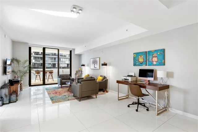 a livingroom with workspace and a window