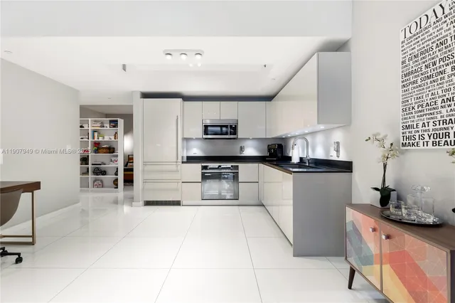 a kitchen with stainless steel appliances granite countertop a sink and cabinets
