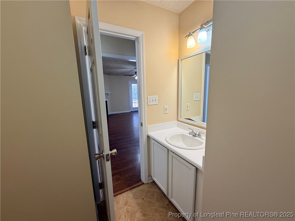 203 Cypress Drive Raeford, NC 28376 - Photo 8 of 21 a bathroom with a sink a toilet and a mirror