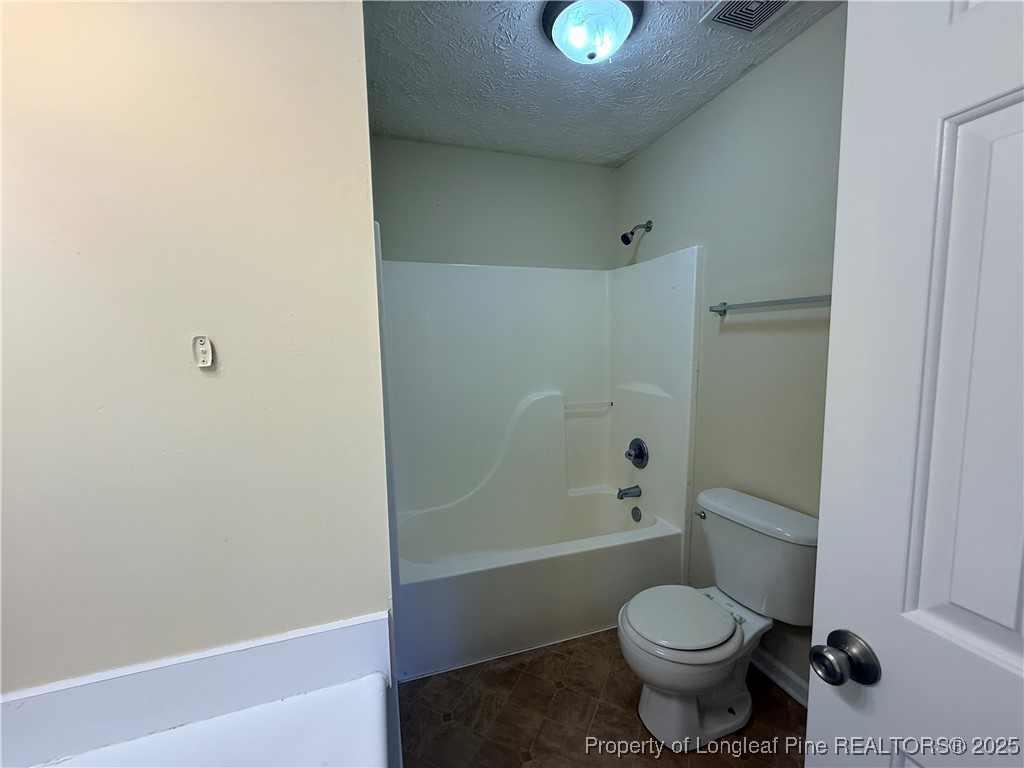 203 Cypress Drive Raeford, NC 28376 - Photo 10 of 21 a bathroom with a toilet and a shower