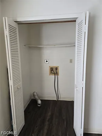 a view of a room with wooden floor and a white door
