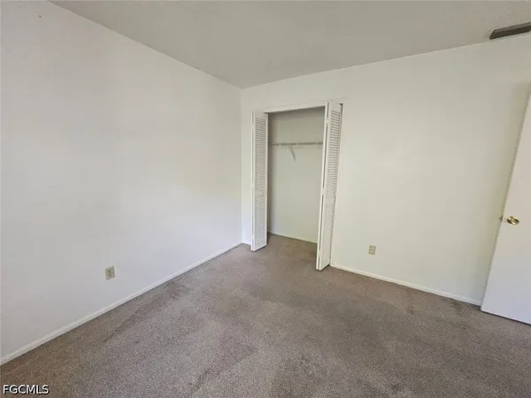 an empty room with closet area
