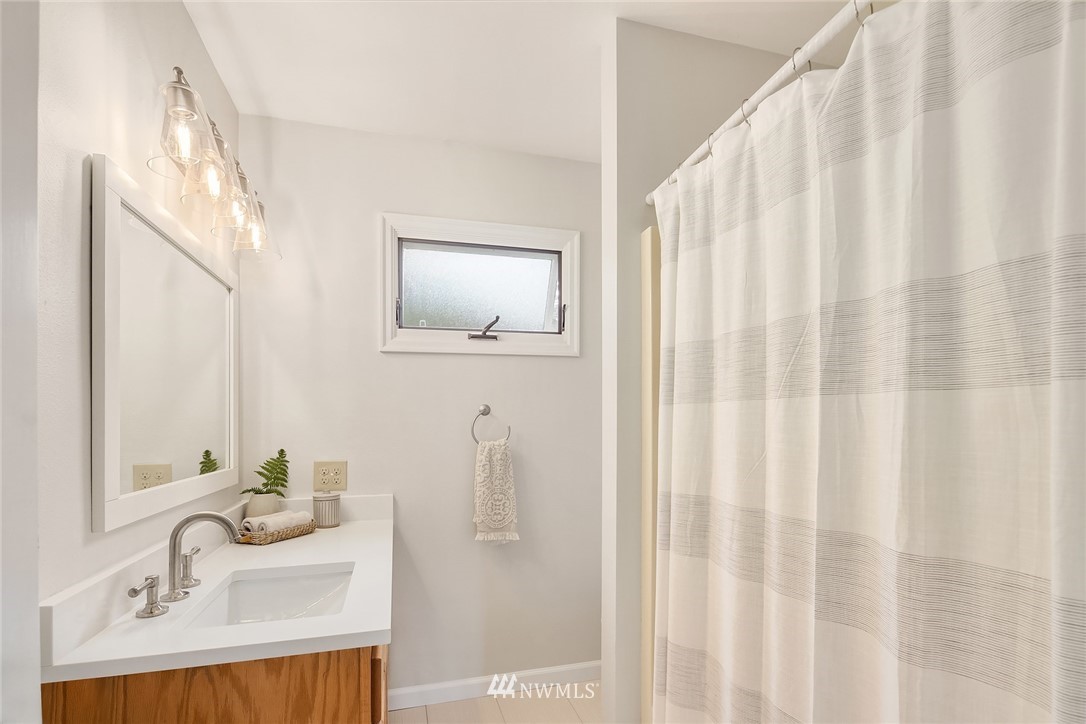 4730 Spring Street Bellingham, WA 98229 - Photo 15 of 30 a bathroom with a sink and a mirror